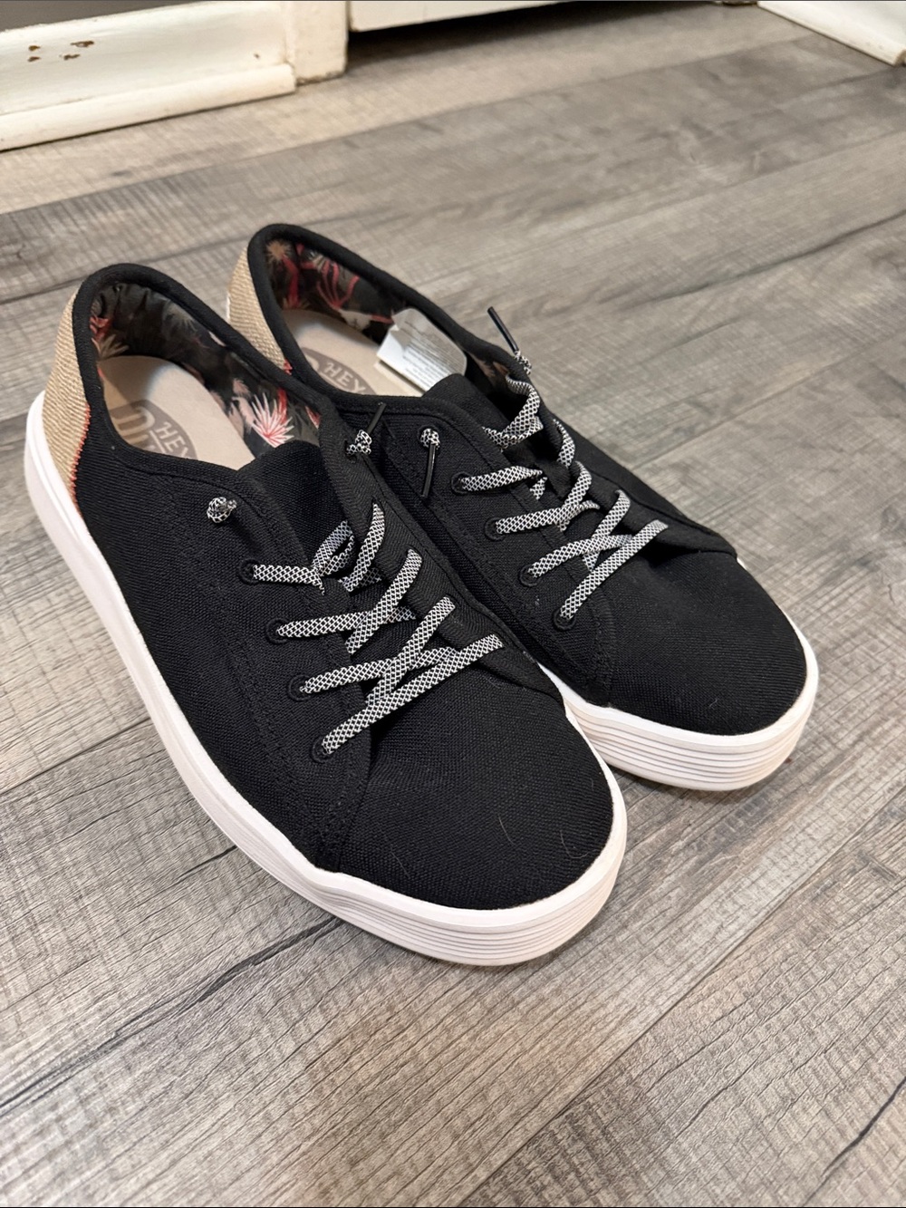 Hey Dude Black Canvas Sneakers with White Sole and Tan Heel Accent.